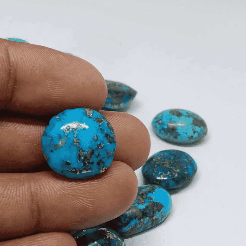 Natural Irani Firoza Stone in Hand, Showcasing its Vibrant Blue Color and Unique Texture