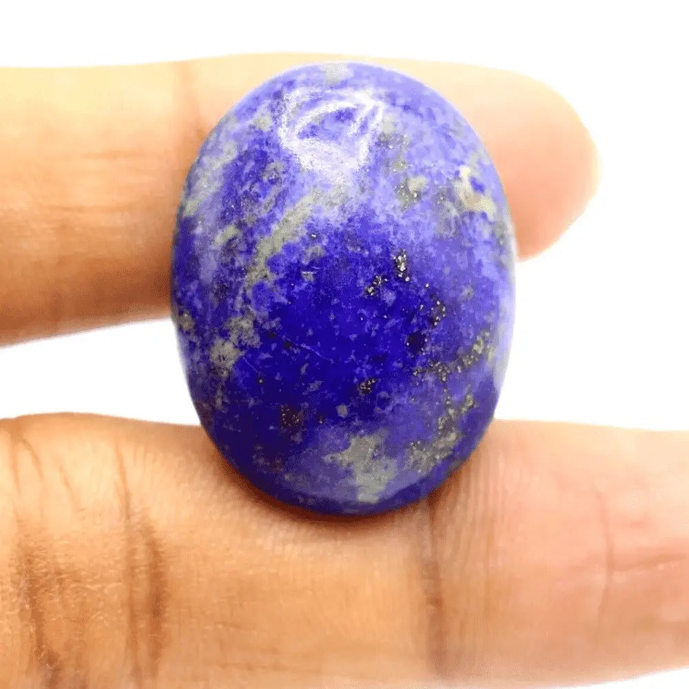 Natural Lapis Lazuli Gemstone Oval Cabochon in Deep Blue Color Held in Hand