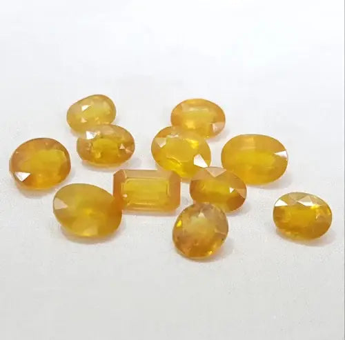 Collection of polished Yellow Sapphire Stones in various shapes and sizes for gemstone enthusiasts