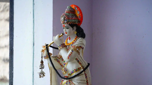 Idol of Lord Krishna adorned with jewelry, representing Lord Natavara Aarti in a serene setting