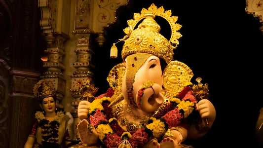 Idol of Lord Ganesha adorned with flowers and gold during Ganpati Ki Seva Aarti celebration