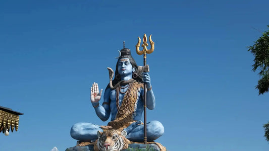 Statue of Lord Shiva in a serene pose, representing the Shiva Mrityunjaya Stotram with a tiger beneath