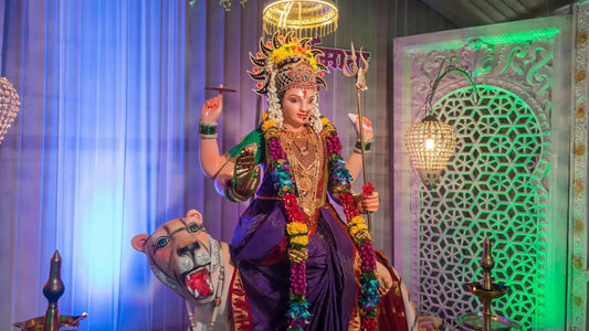 Tantroktam Devi Suktam statue adorned with flowers, standing on a lion amid colorful decorations