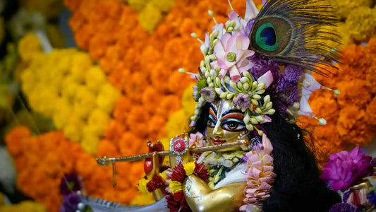 Colorful idol of Lord Krishna adorned with flowers, representing Shri Govinda Ashtakam with vibrant decorations