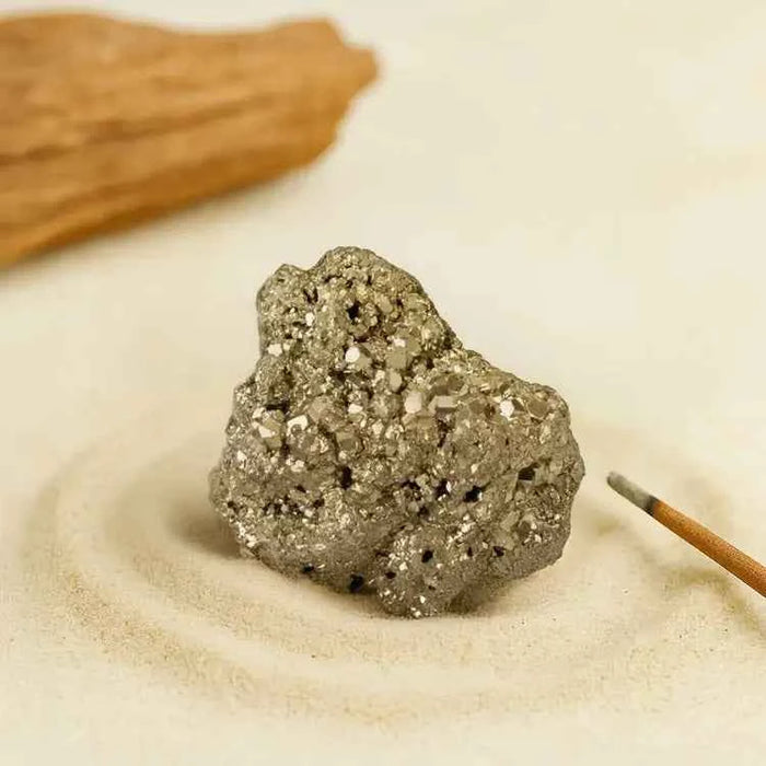 RudraGram certified pyrite gemstone with natural sparkle and unique texture on a sandy background